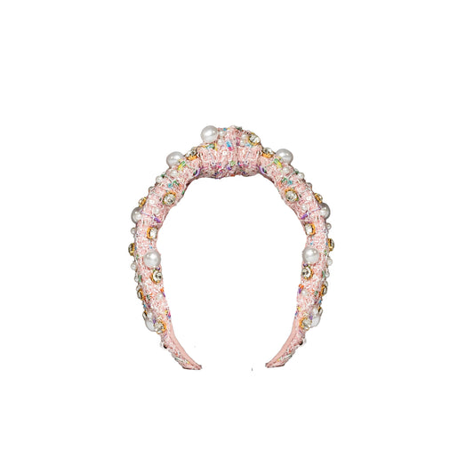 Decorative headband with pearls and crystals on a white background